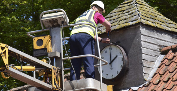 Person Repairing Clock