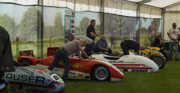 People Looking At Racing Vehicles